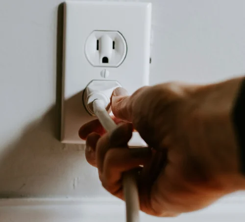 plugging in power to wall outlet